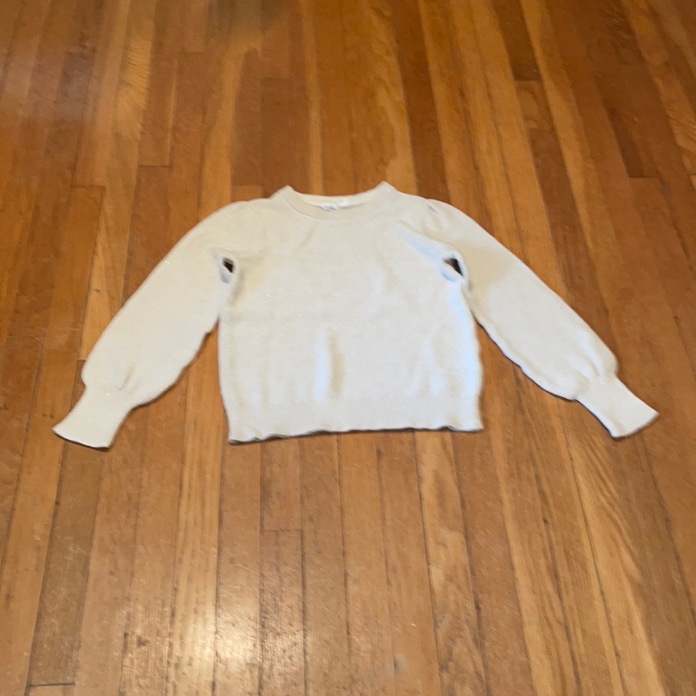 Cream colored sweater with gold flecks.